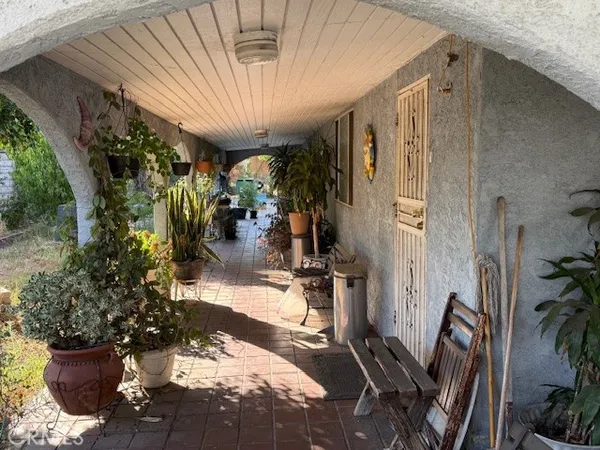 a view of a porch with potted plants