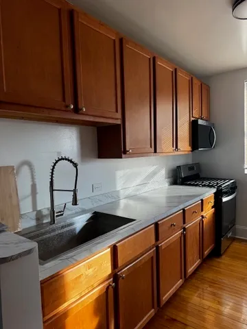 a kitchen with stainless steel appliances granite countertop a sink and cabinets