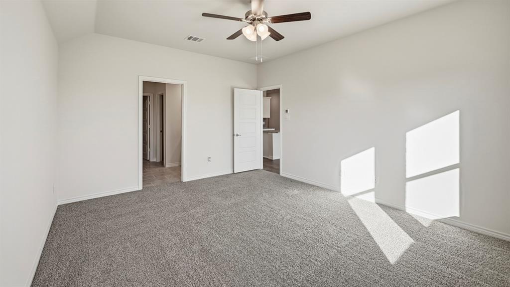 403 Flintlock Road Caddo Mills, TX 75135 - Photo 17 of 26 Unfurnished bedroom featuring carpet and ceiling fan