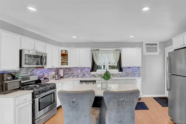 a kitchen with stainless steel appliances a sink stove and refrigerator