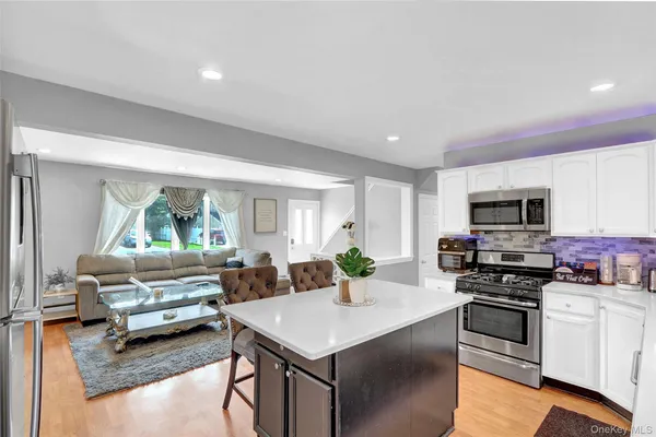 a kitchen with a stove a sink and a refrigerator