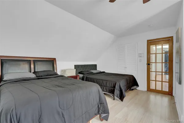 a bedroom with two beds and a window