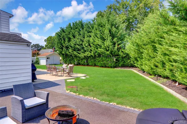 a view of a backyard with couches plants and lake view