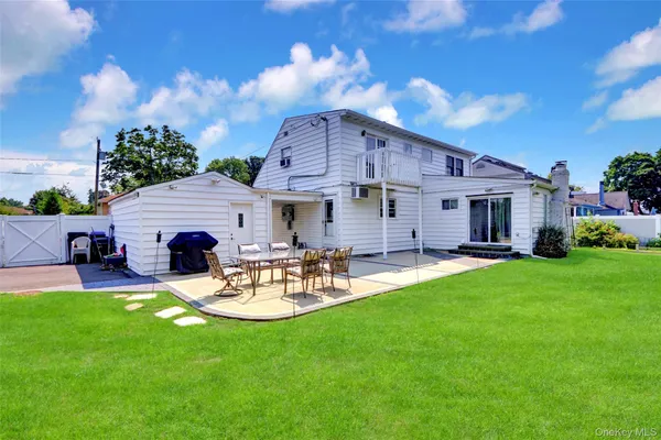 a view of a house with a yard and sitting area