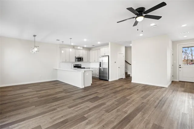 a view of a kitchen with a sink and a refrigerator