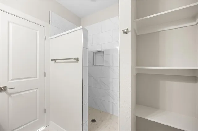 a bathroom with a glass shower door