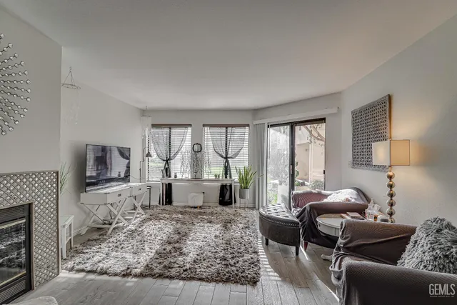 a living room with furniture large window and a flat screen tv