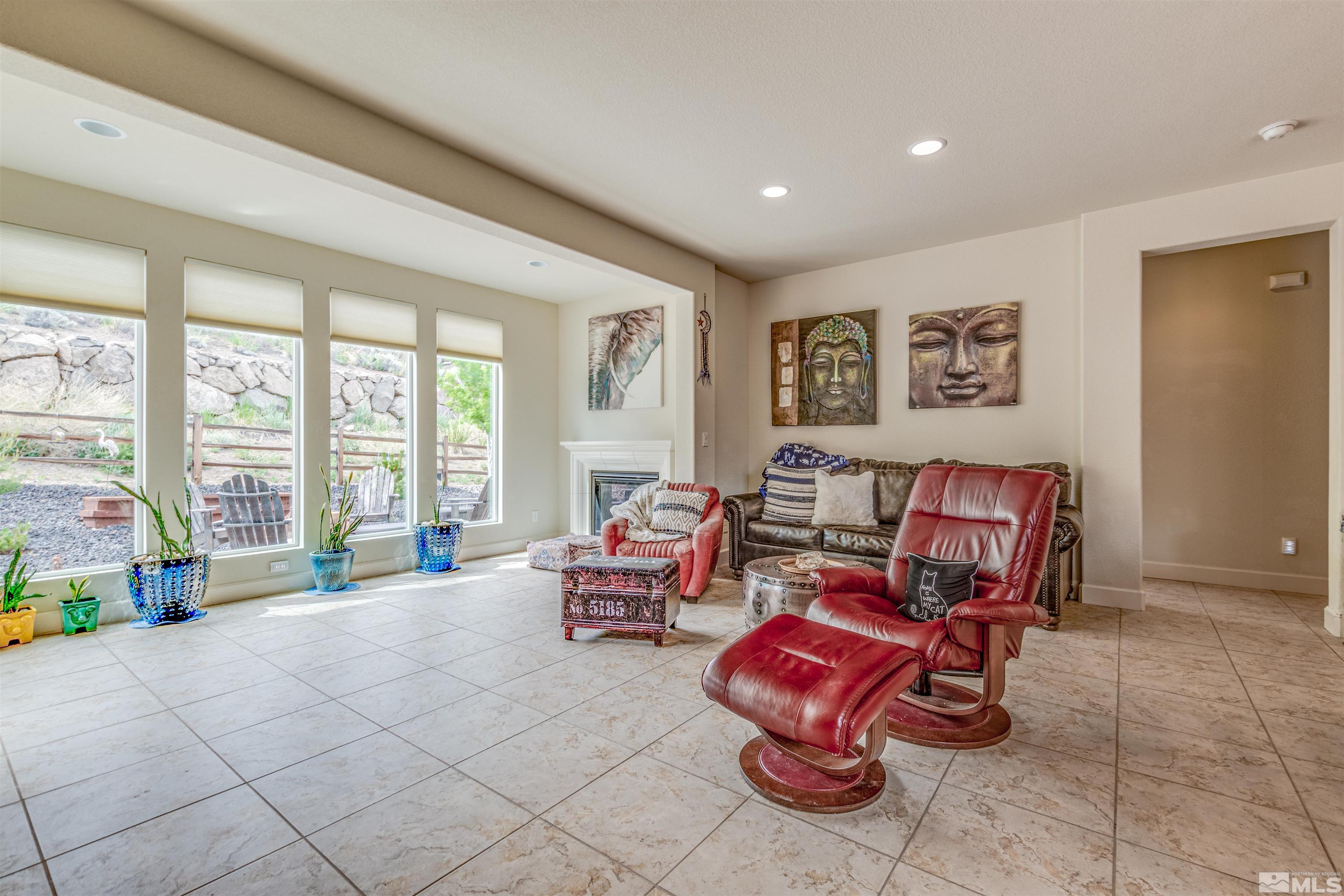 1180 Wakefield Trail Reno, NV 89523 - Photo 9 of 21 a living room with furniture a flat screen tv and a large window
