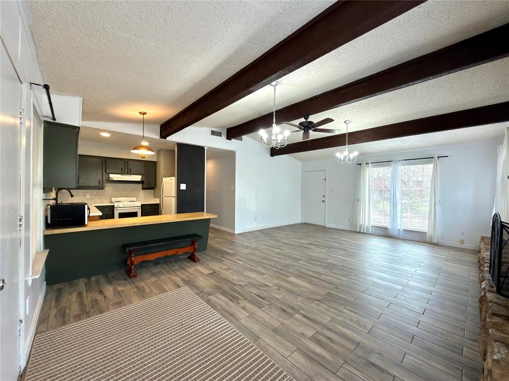 170 Granada Street Payne Springs, TX 75156 - Photo 8 of 20 a view of a hallway with wooden floor and furniture