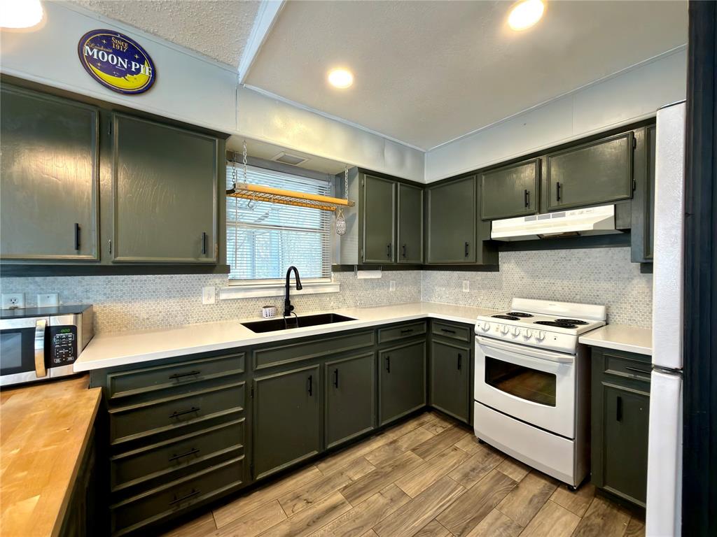 170 Granada Street Payne Springs, TX 75156 - Photo 10 of 20 a kitchen with stainless steel appliances granite countertop a stove and a sink