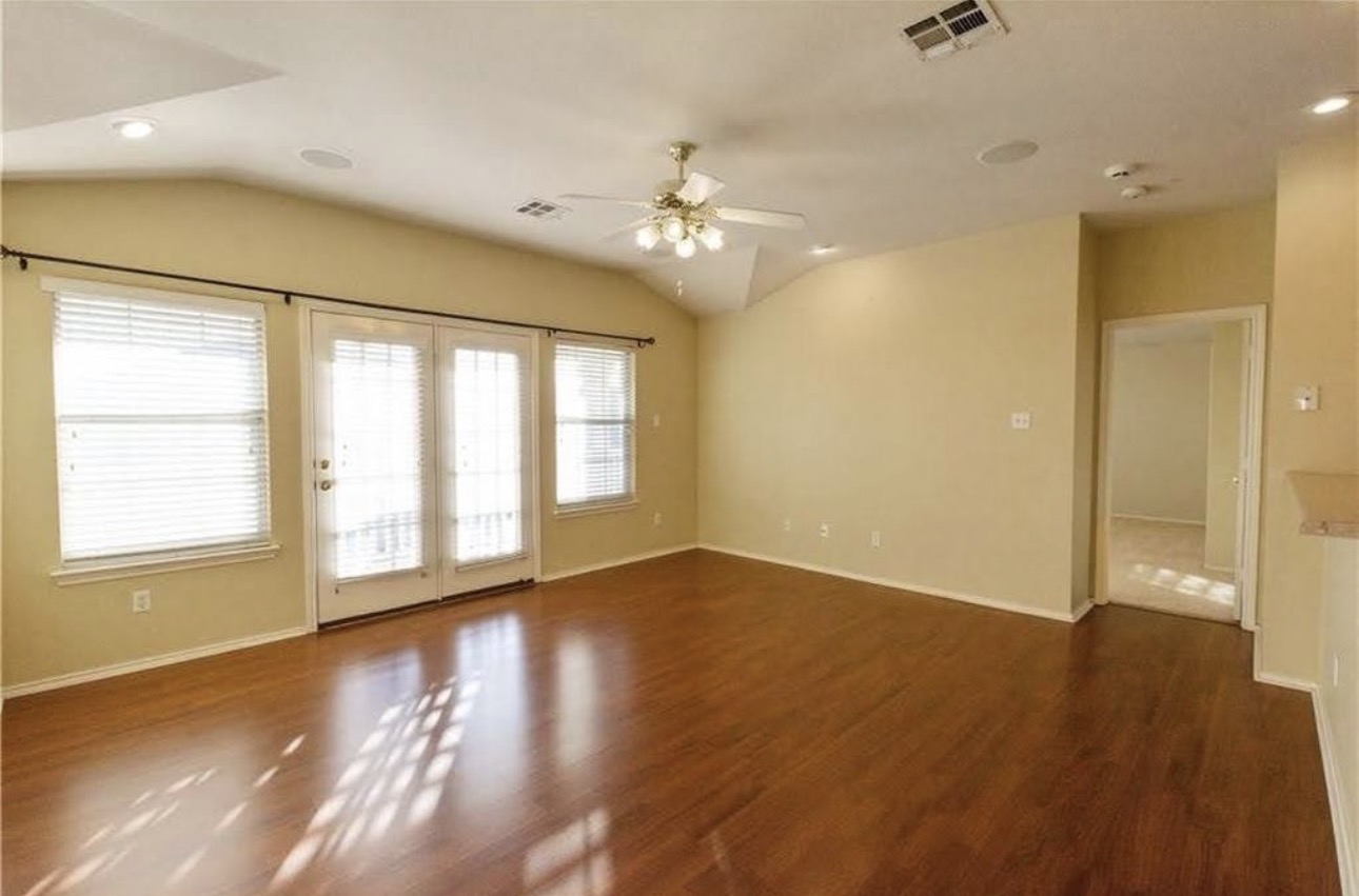 1900 Scofield Ridge Parkway, Unit 3101 Austin, TX 78727 - Photo 12 of 24 Spacious room featuring vaulted ceilings, wood-finish flooring, recessed lighting, and a ceiling fan