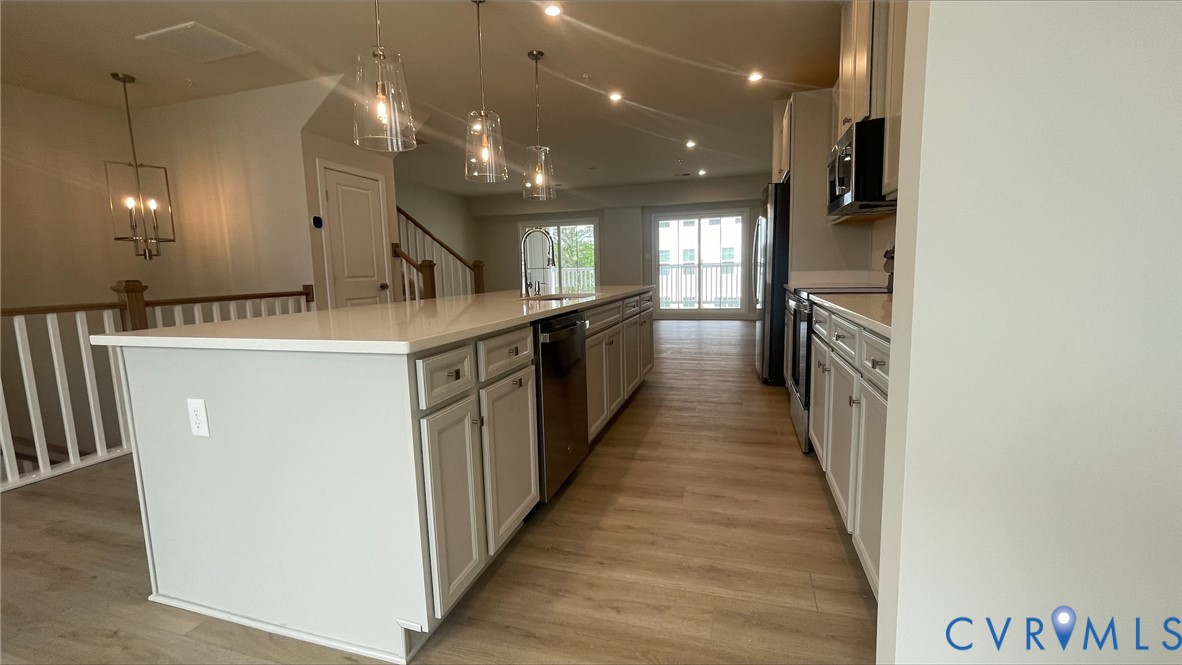 2860 Calgary Lane Chester, VA 23831 - Photo 4 of 16 a kitchen with kitchen island a sink a stove and a refrigerator