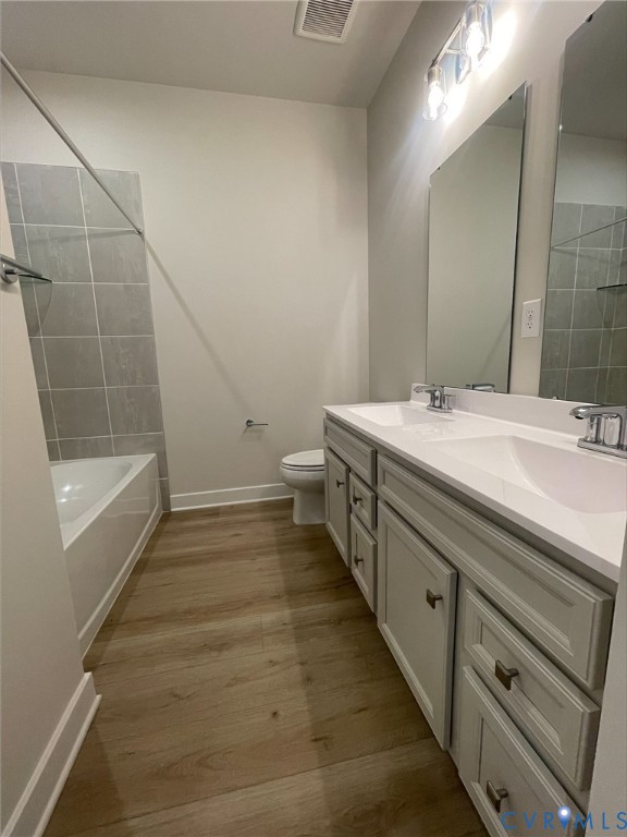 2860 Calgary Lane Chester, VA 23831 - Photo 10 of 16 a bathroom with a double vanity sink a mirror and a bathtub