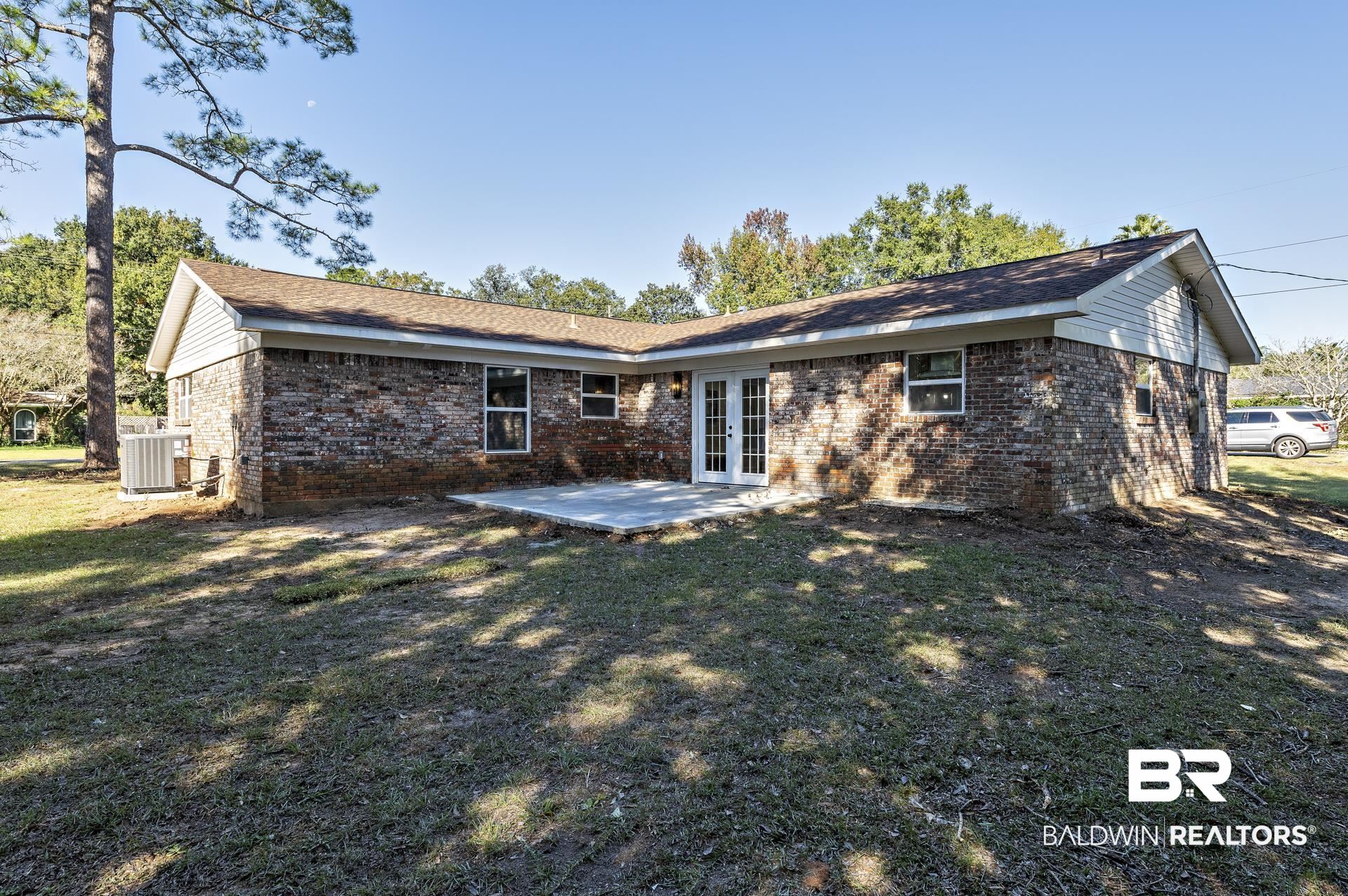 6001 Camp Halls Mill Road Mobile, AL 36619 - Photo 46 of 52 Back of property featuring a patio, french doors, brick siding, and a lawn