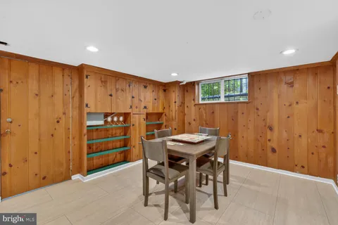 a view of a kitchen with furniture and wooden floor