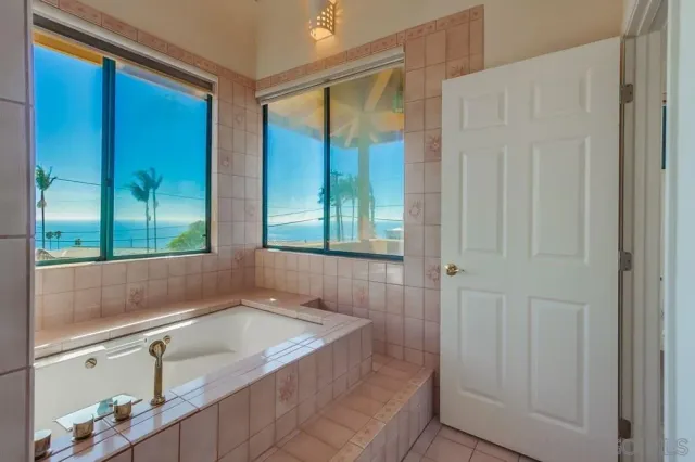 a bathroom with a sink a mirror and a shower