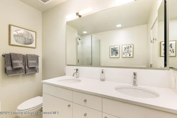 a white toilet sitting next to a bathroom sink