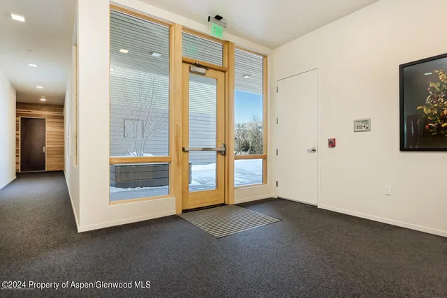 a roof deck with couches and wooden floor