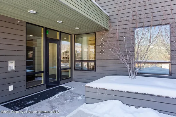 a view of a building with snow on the road