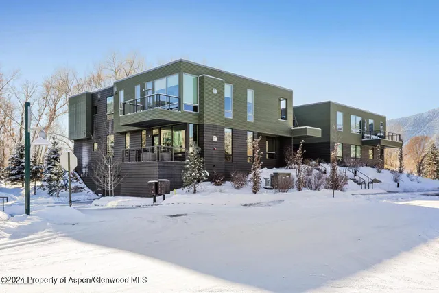 a view of a wooden house with a snow