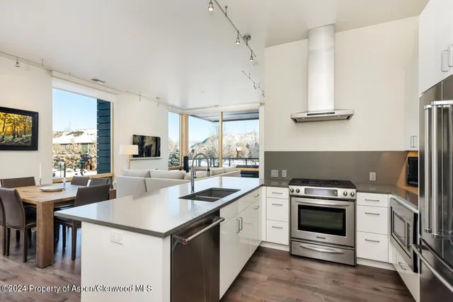 a kitchen with a stove a sink and a refrigerator