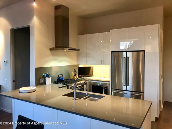 a kitchen with stainless steel appliances a sink stove and refrigerator