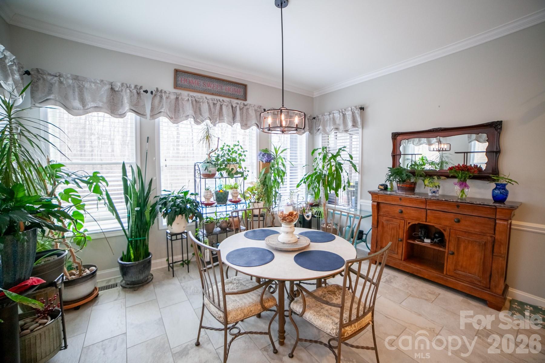 790 Brandon Road Clover, SC 29710 - Photo 14 of 48 a dining room with furniture potted plants and large windows