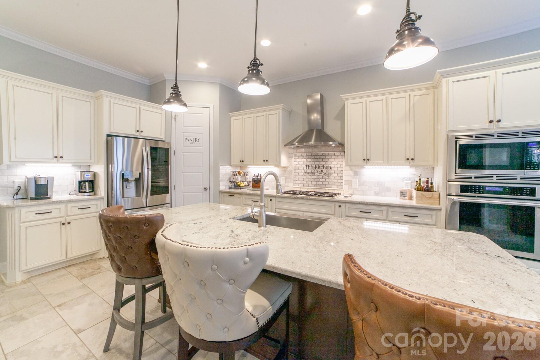 790 Brandon Road Clover, SC 29710 - Photo 26 of 48 a kitchen with stainless steel appliances kitchen island granite countertop a table chairs and a refrigerator