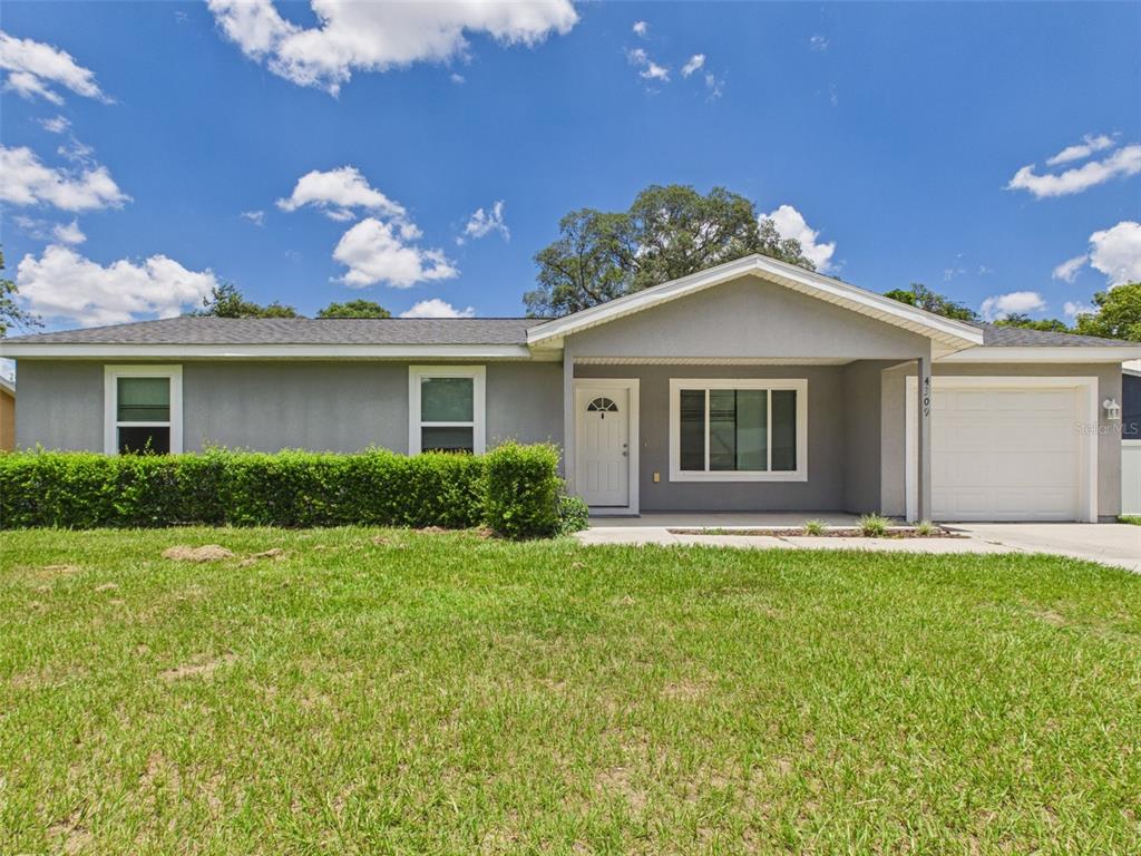 4309 Southwest 143rd Ln Road Ocala, FL 34473 - Photo 1 of 21 a front view of a house with a garden