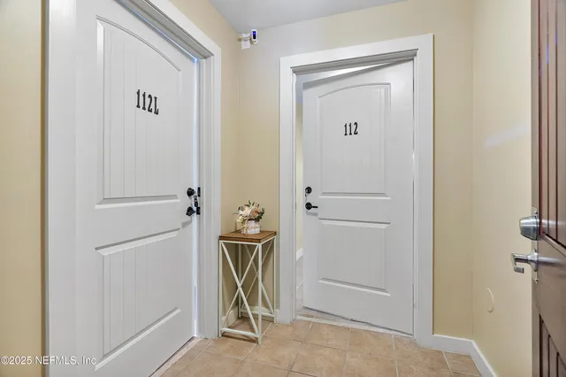 a view of a hallway with dining area and glass door