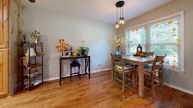 a dining room with furniture window and wooden floor