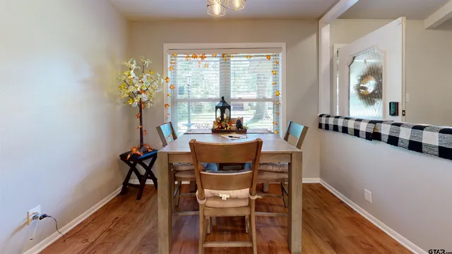 a dining room with furniture and window