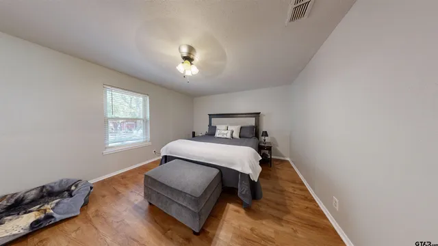 a bedroom with a bed and a window