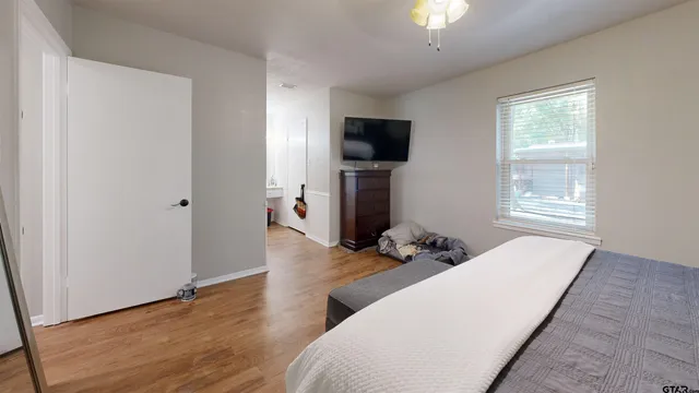 a living room with furniture a flat screen tv and a window