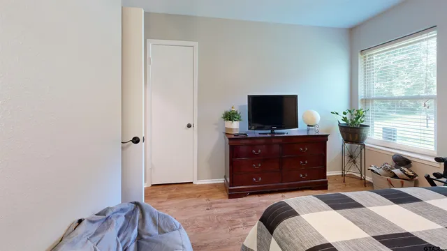 a bedroom with a bed and flat screen tv