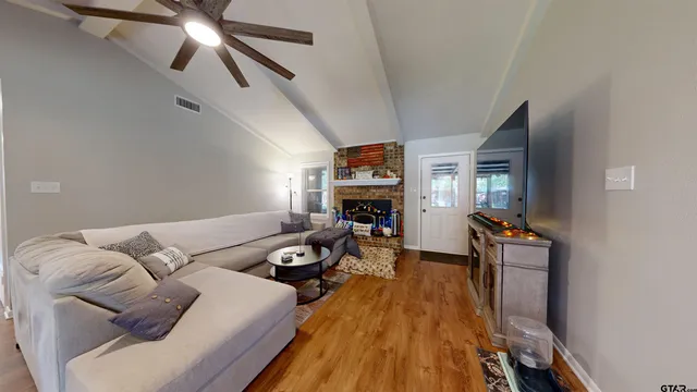 a living room with furniture and a fireplace