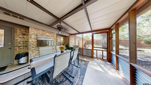 a view of a dining room with furniture large windows and wooden floor