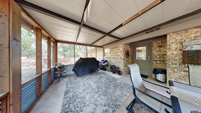 a living room with furniture large windows