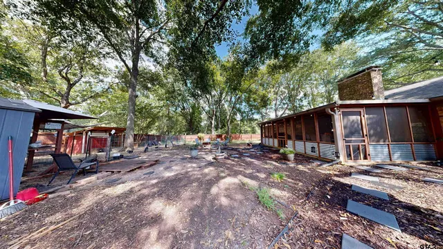 a backyard of a house with barbeque oven table and chairs