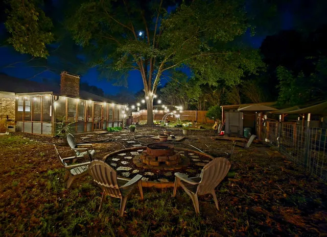 a view of a backyard with sitting area