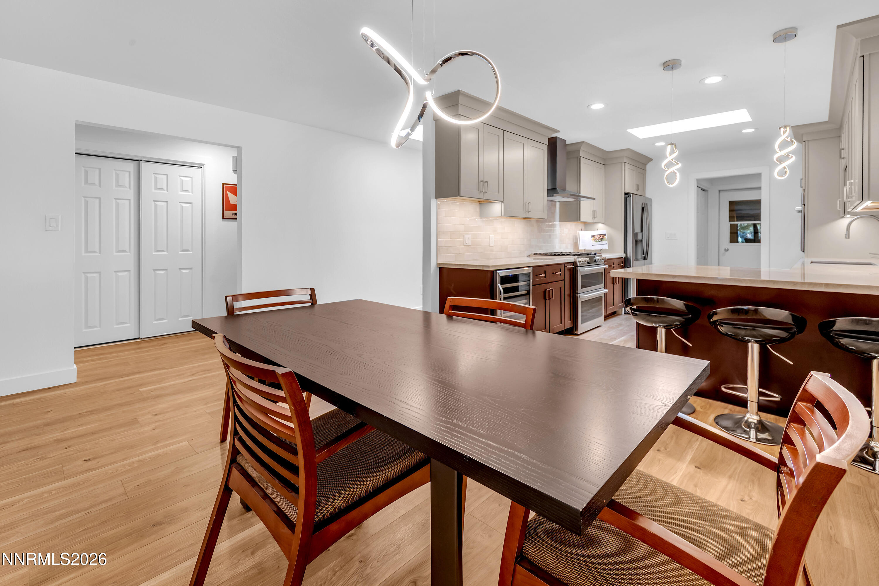 4915 Lakeridge Terrace West Reno, NV 89509 - Photo 20 of 41 a living room with stainless steel appliances kitchen island a table chairs and wooden floor