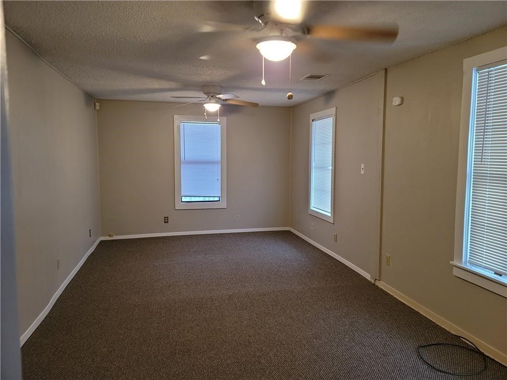 18501 Blake Manor Road Manor, TX 78653 - Photo 4 of 10 an empty room with windows and entrance