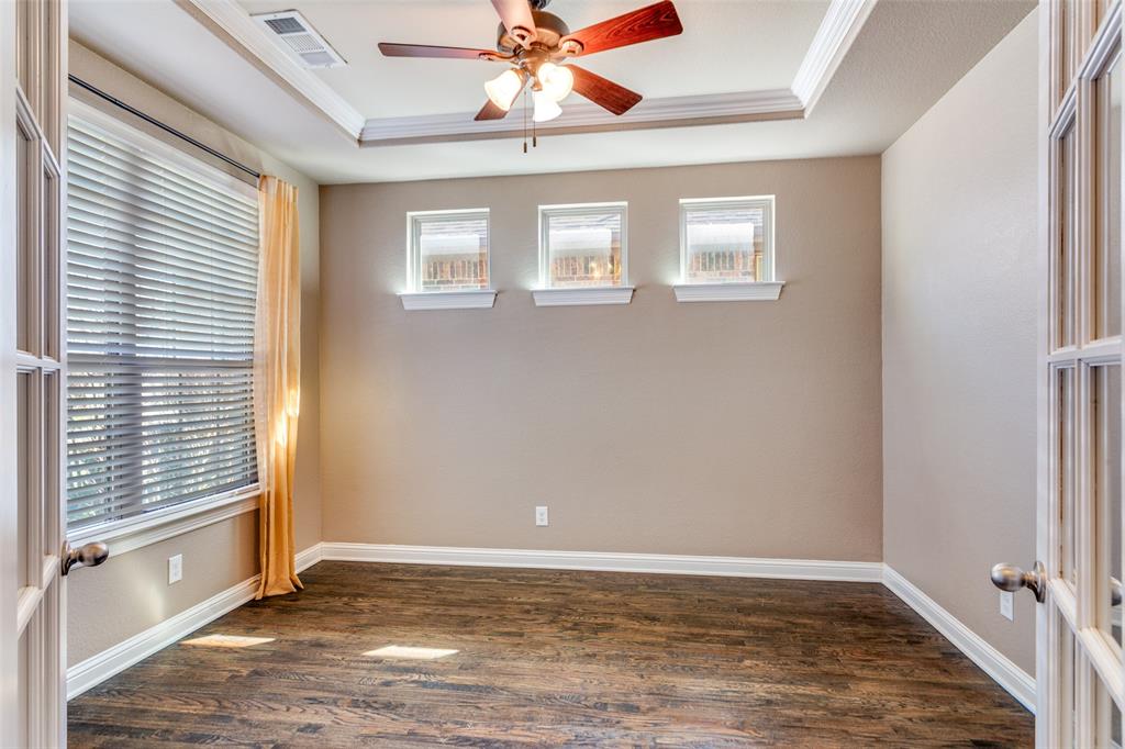 1505 5th Street Argyle, TX 76226 - Photo 4 of 25 an empty room with wooden floor fan and windows