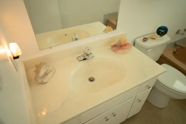 a view of a house with backyard porch and wooden fence