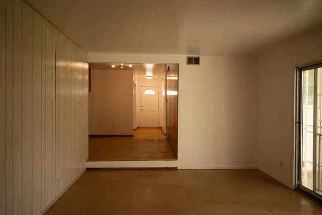 a view of an empty room with a fireplace