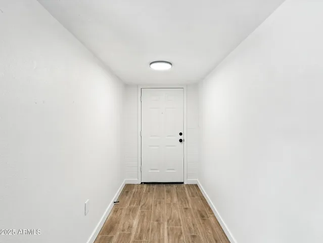 a view of a hallway with wooden floor