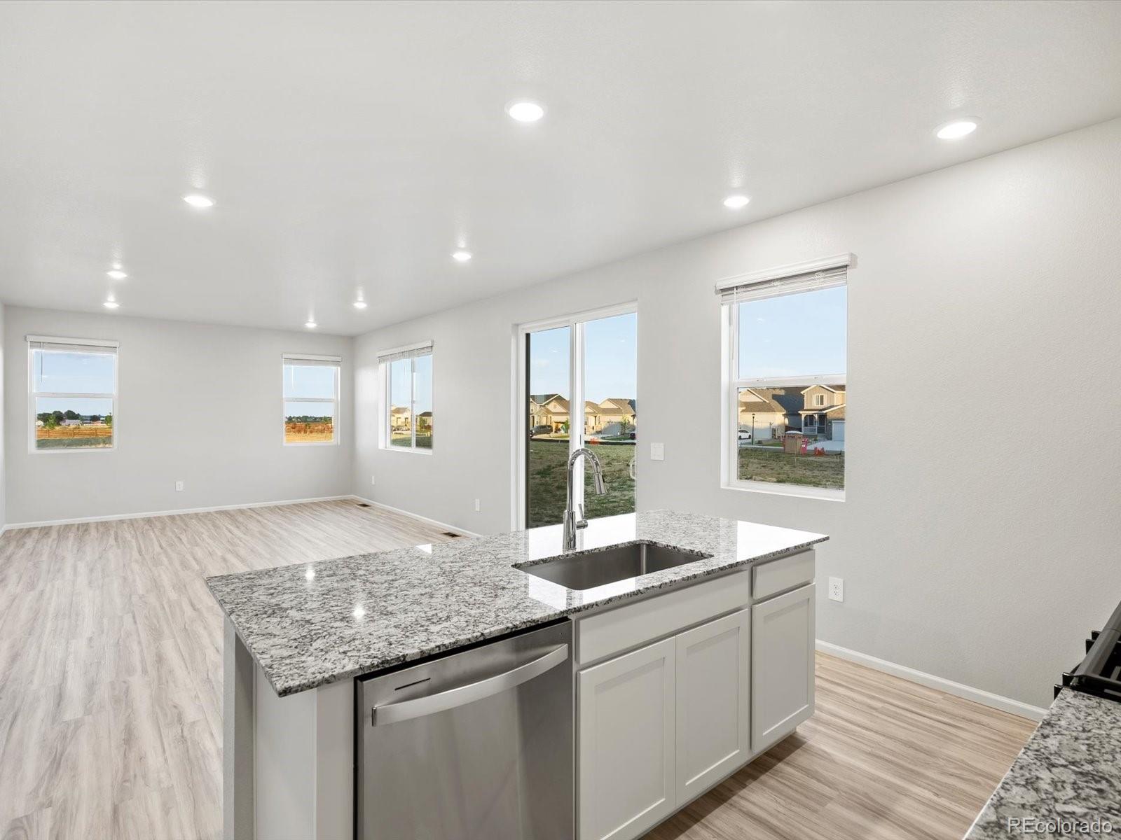 4684 Rabbitbrush Street Johnstown, CO 80534 - Photo 21 of 45 a spacious bathroom with a granite countertop sink and a mirror