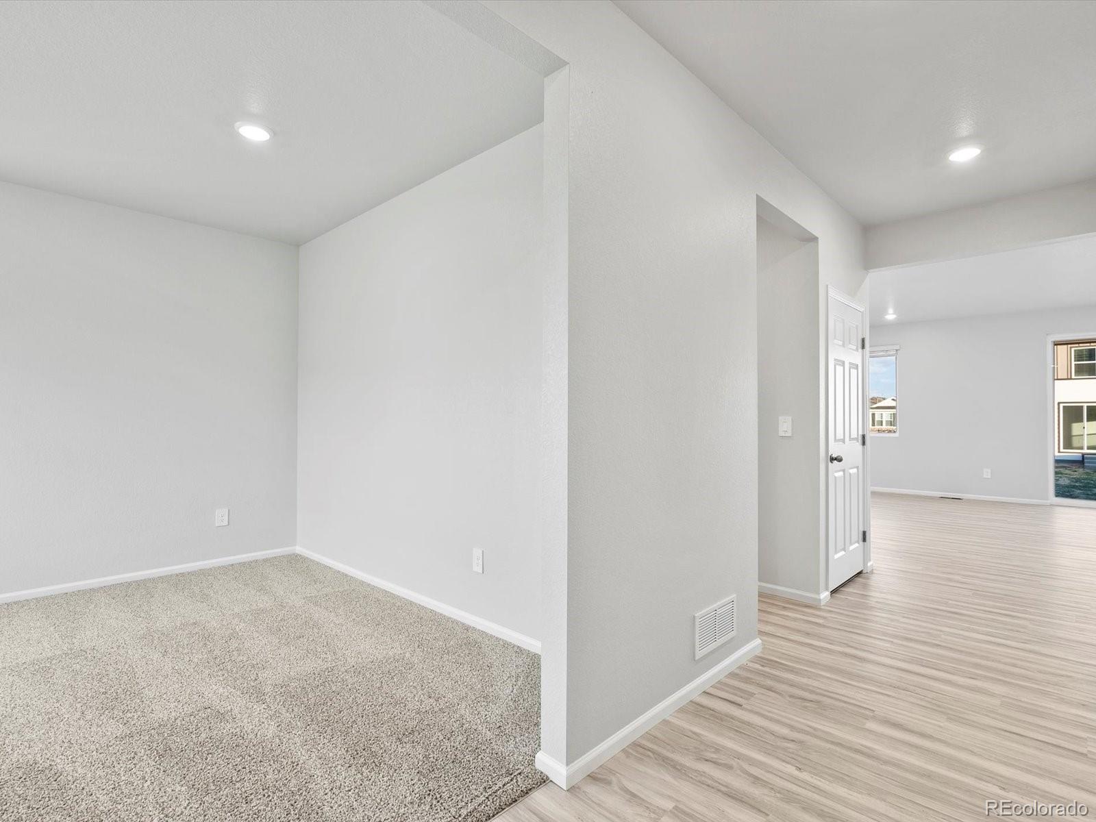 4684 Rabbitbrush Street Johnstown, CO 80534 - Photo 3 of 45 a view of hallway with wooden floor