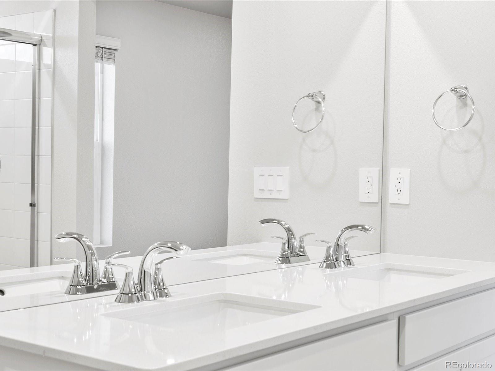 4684 Rabbitbrush Street Johnstown, CO 80534 - Photo 32 of 45 a bathroom with double vanity sinks and a mirror