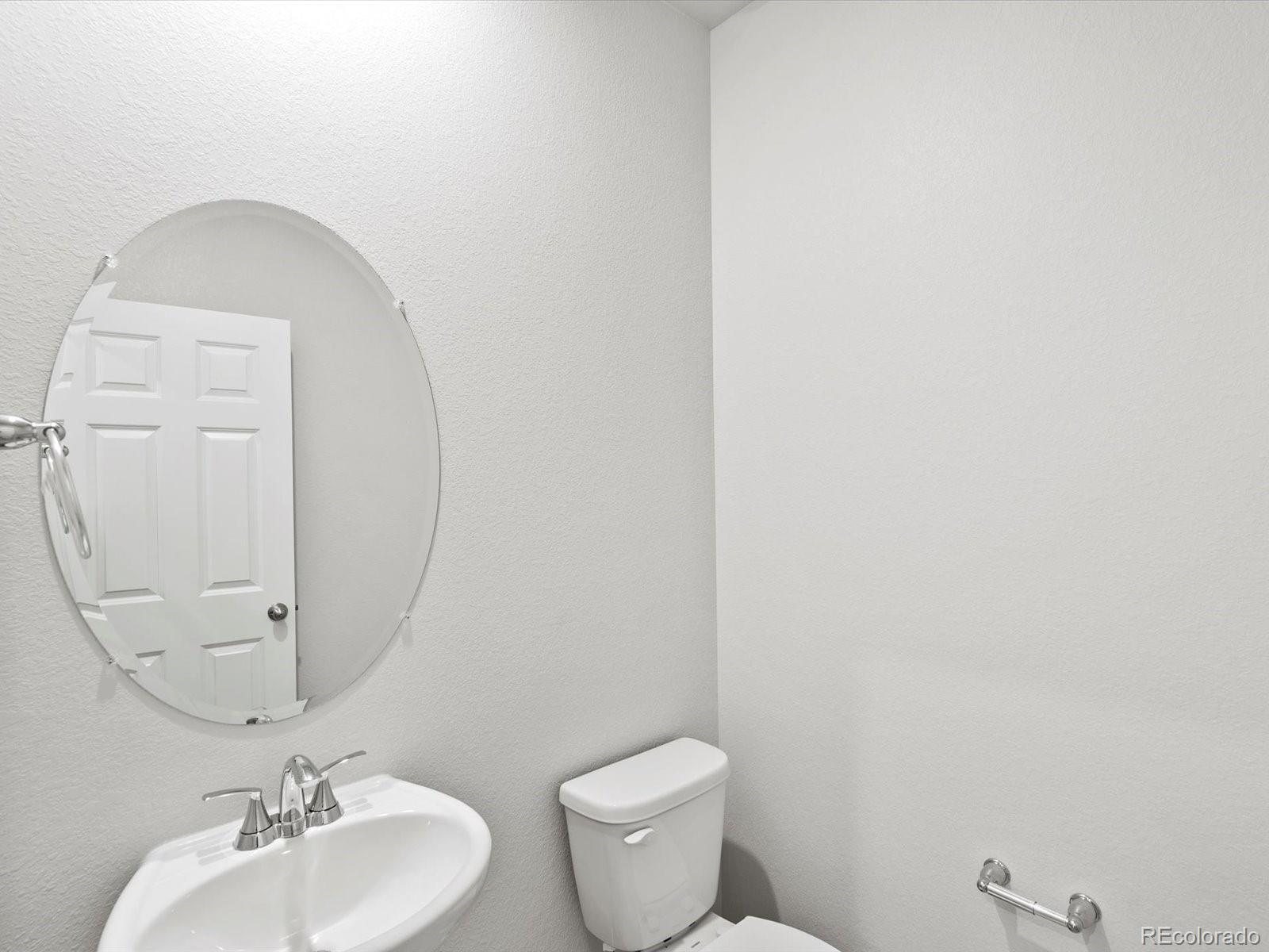 4684 Rabbitbrush Street Johnstown, CO 80534 - Photo 9 of 45 a bathroom with a toilet a sink and mirror